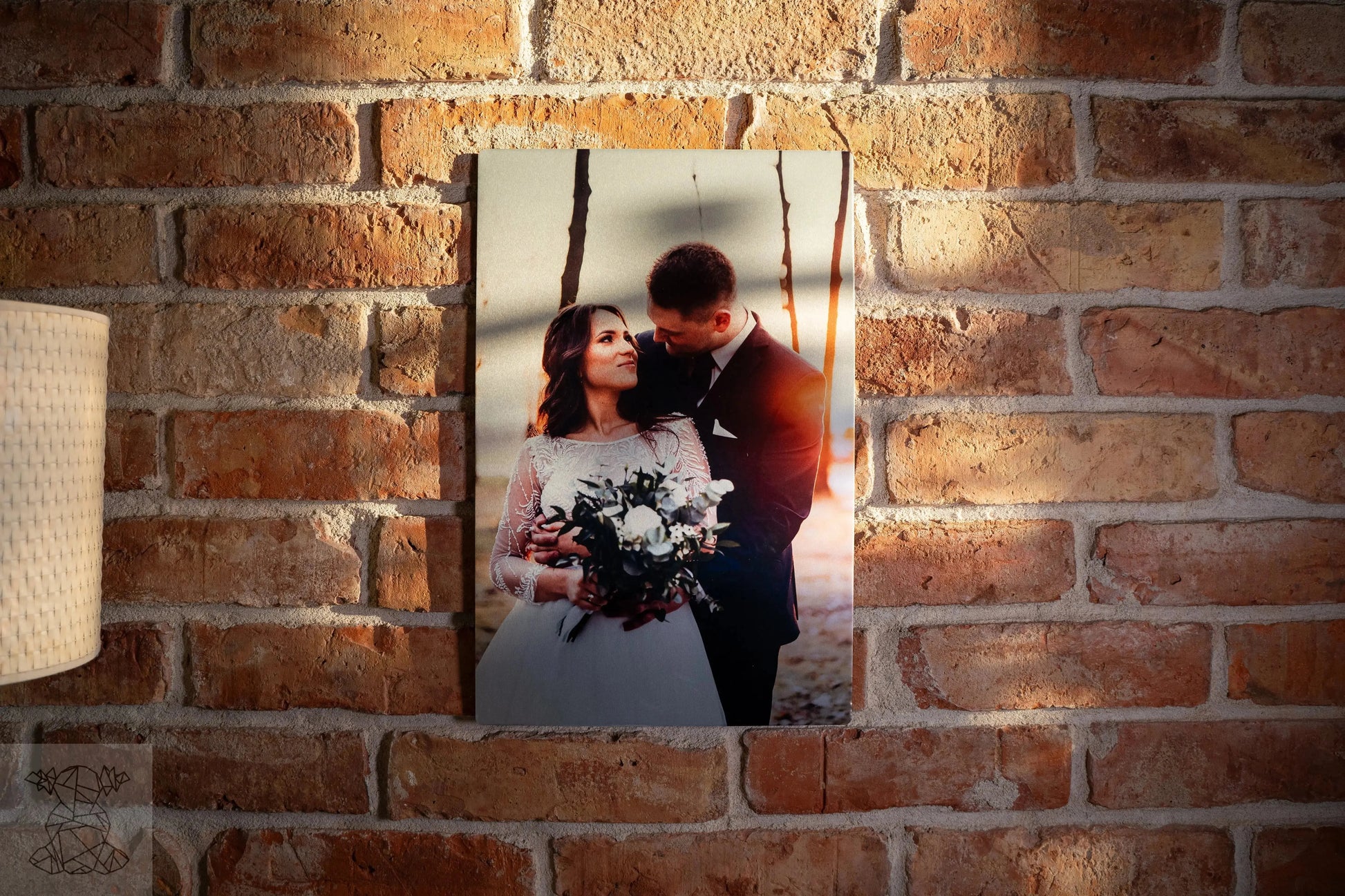 Large matte metal print of bride and groom on brick wall, illustrating rich colour depth for wedding photography.