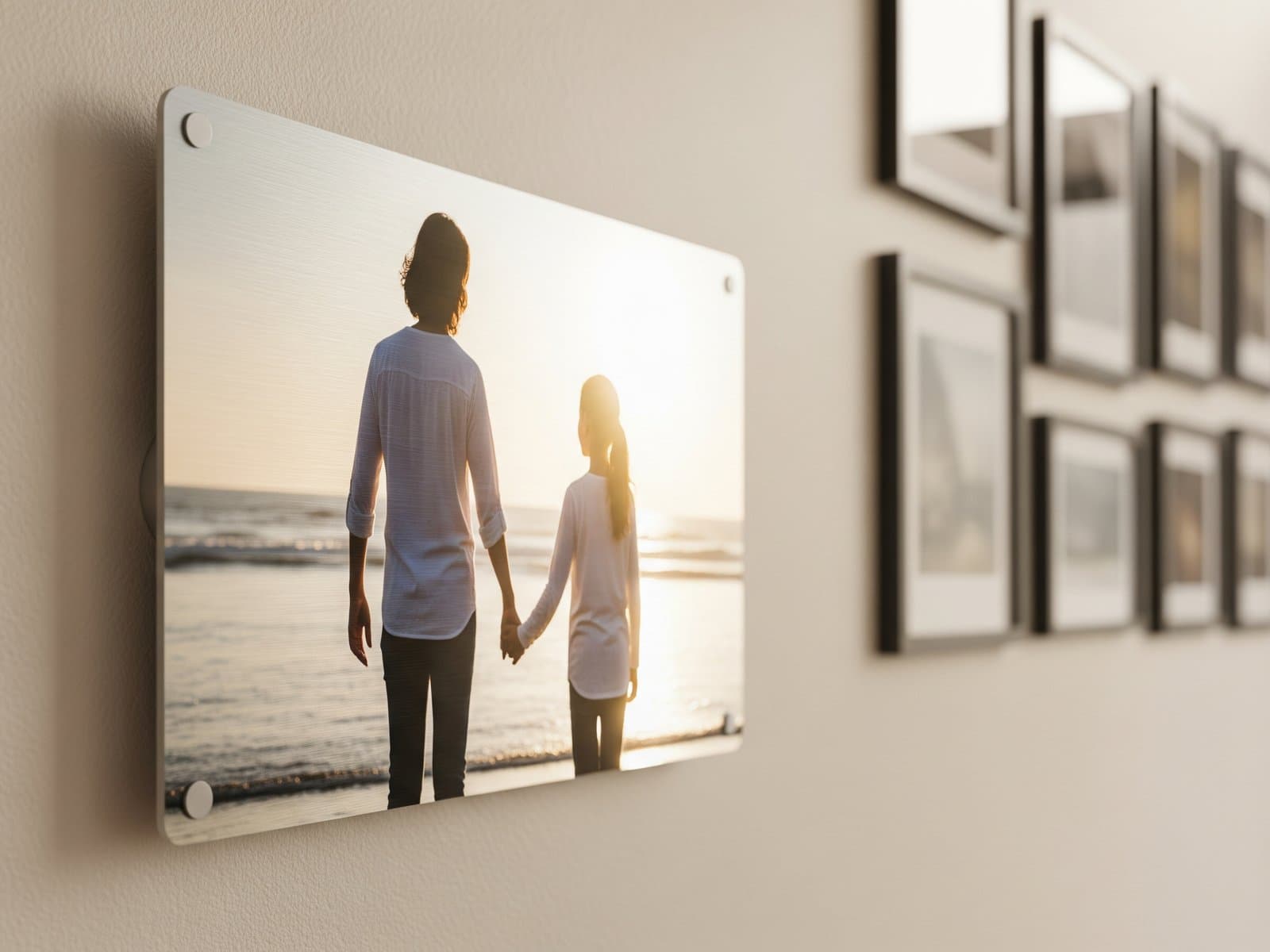 Personal family portrait on a glossy metal print in sharp focus, with framed gallery artwork softly blurred in the background