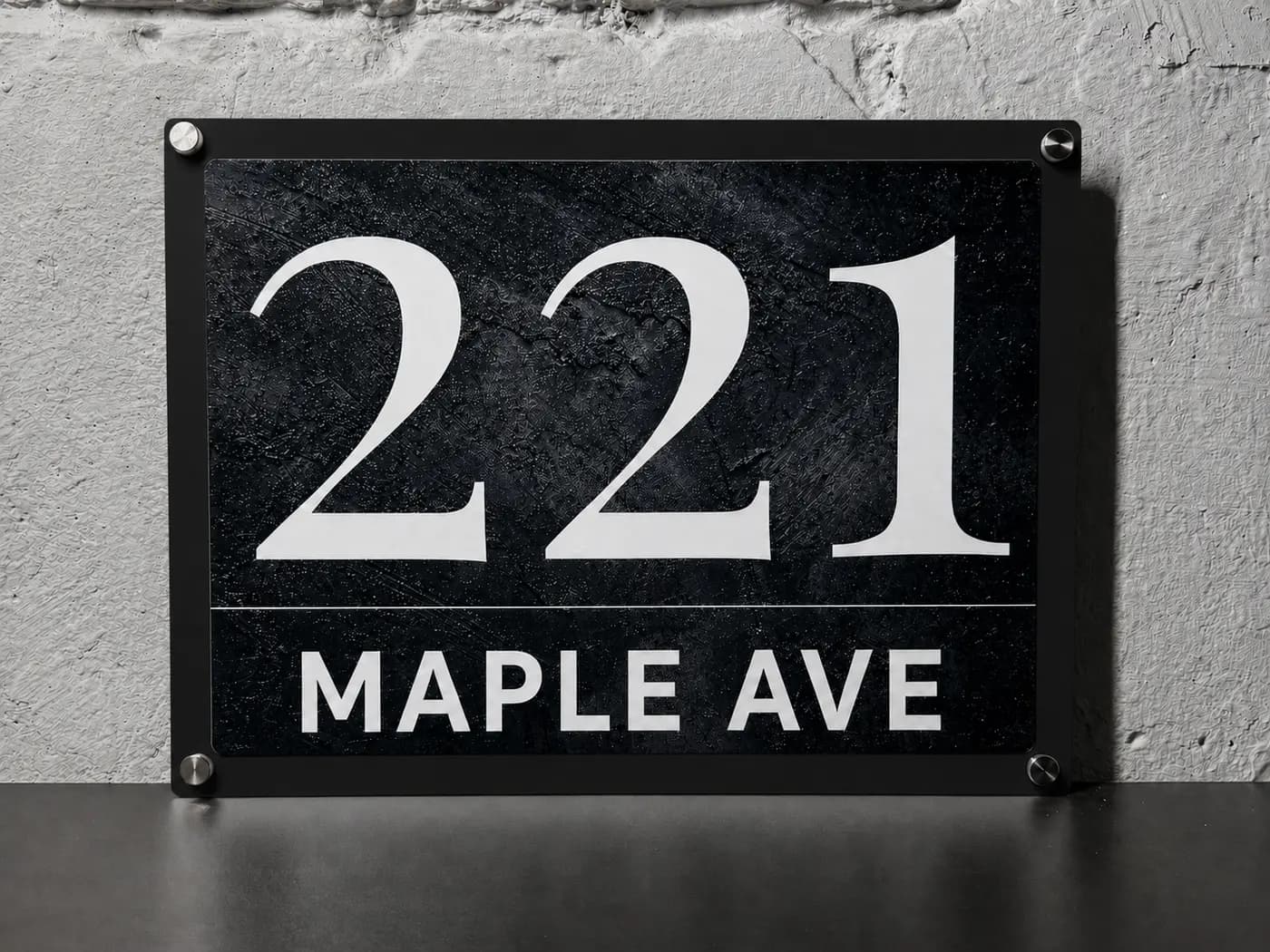 Anthracite concrete metal address sign, landscape format, with inox standoff bolts — studio shot