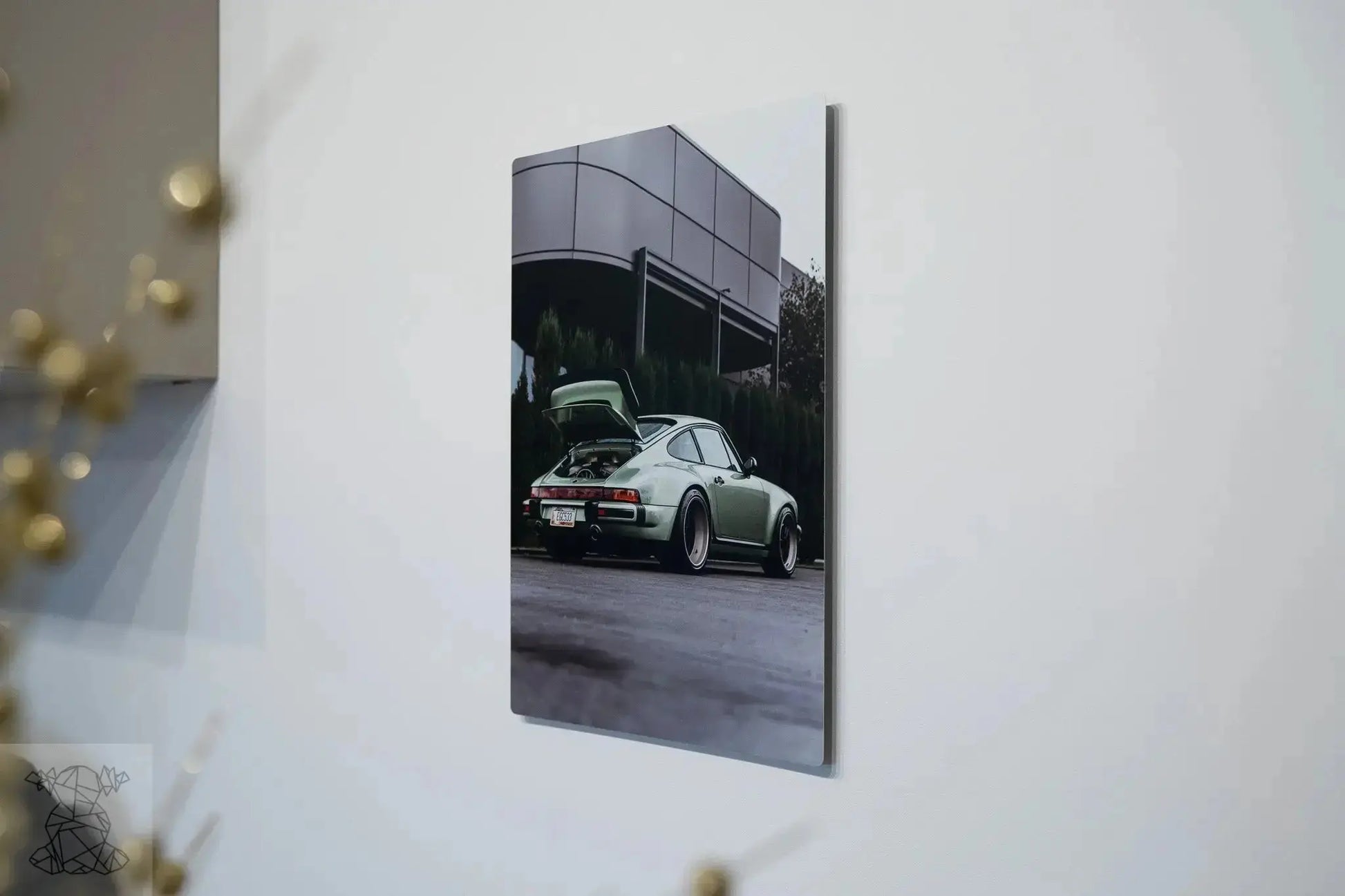 Large matte metal print of classic Porsche mounted on white wall, showing sleek wall-art finish and depth.