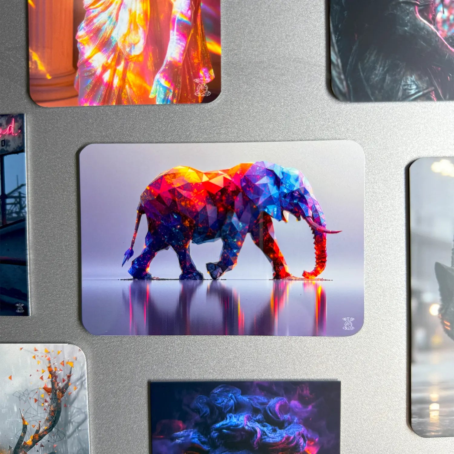 Colorful geometric elephant design on a metallic surface with other artistic images.