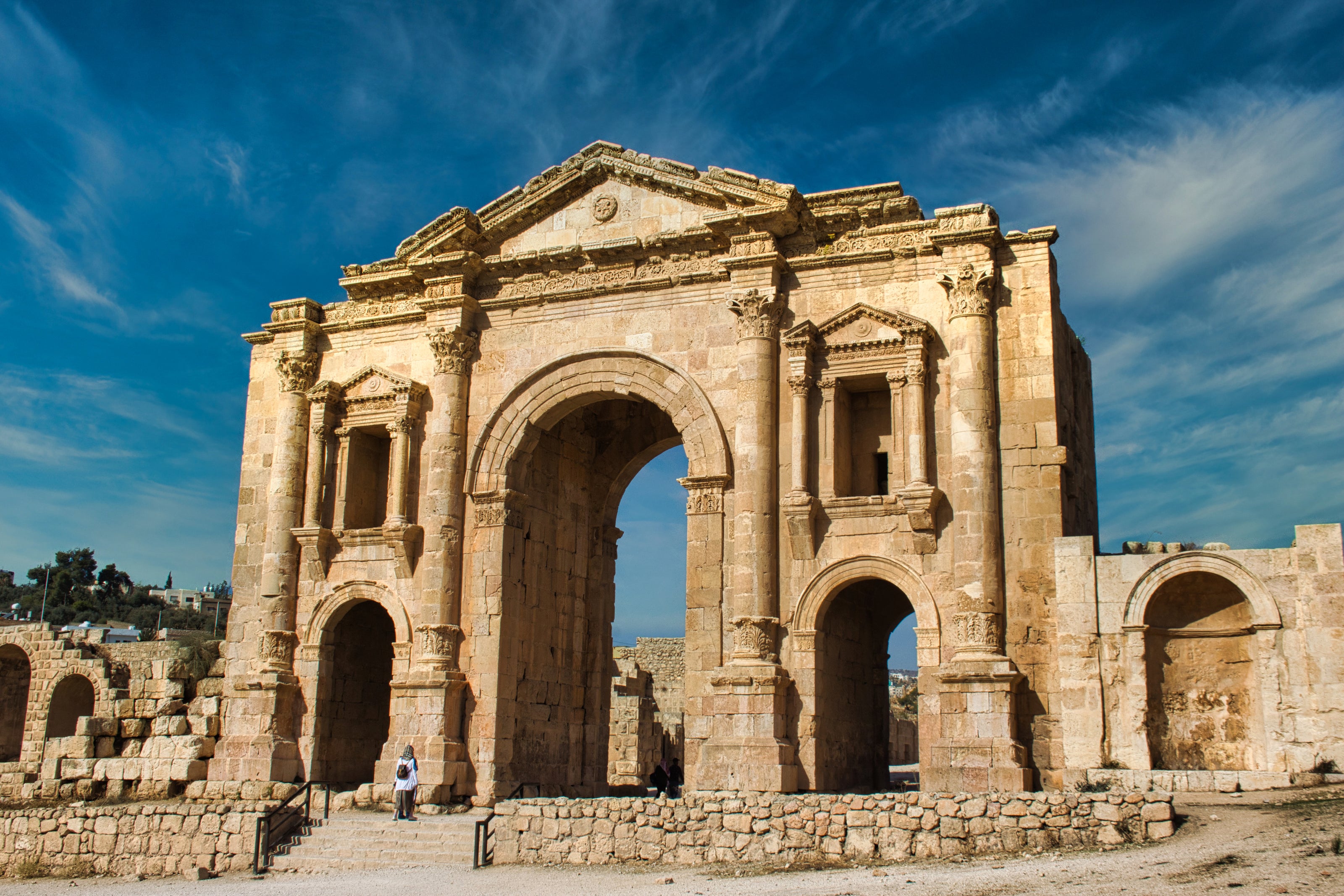 Tourist in front of the ancient Roman Arch of Hadrian in Jerash — a stunning travel-themed design for custom magnets or large metal prints.